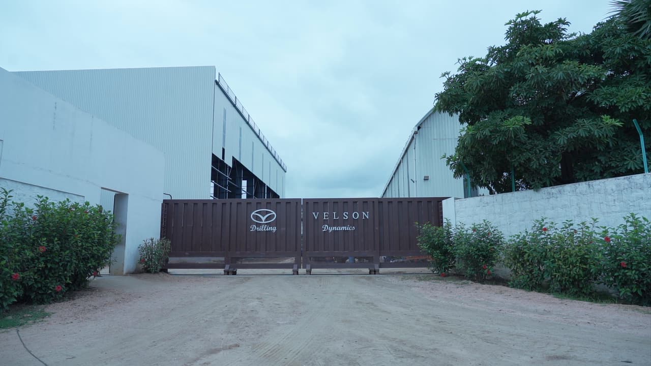 Gated entrance to the Velson plant, fabrication sheds behind